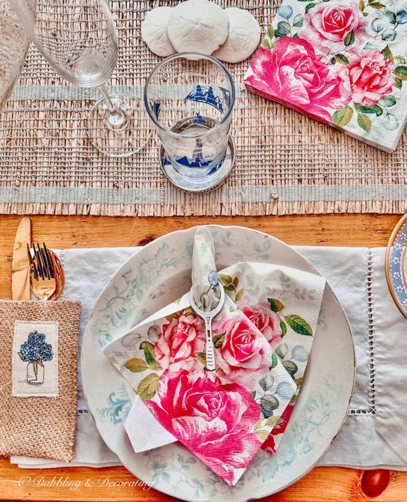 Thrifted summer table decorations with pink and blue and white color palette in antique styled dining room.