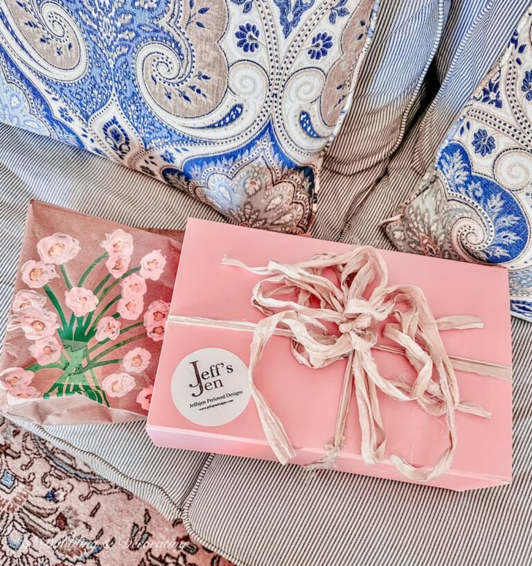 Pink box decorated as a vintage gift ideas with a quilted jacket inside.