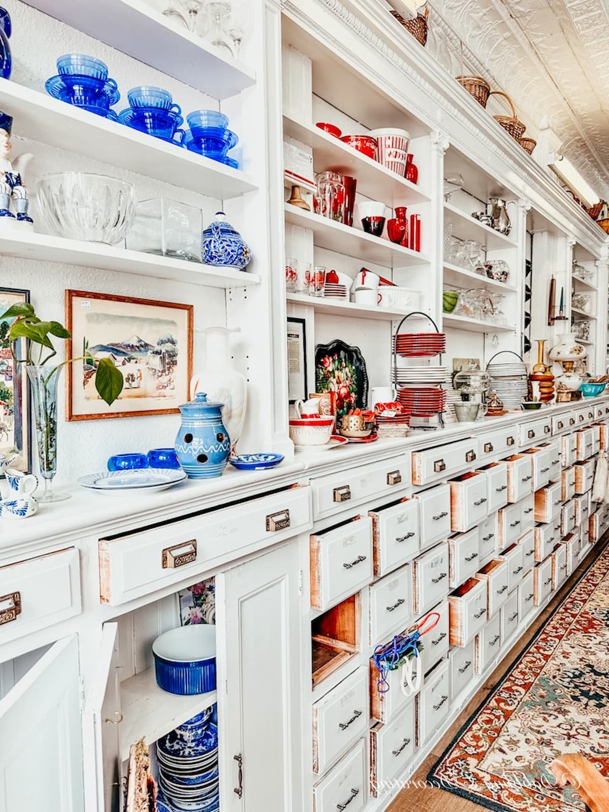 Another Chance Thrift Store with white wall cabinetry and vintage thrifted decor accents.