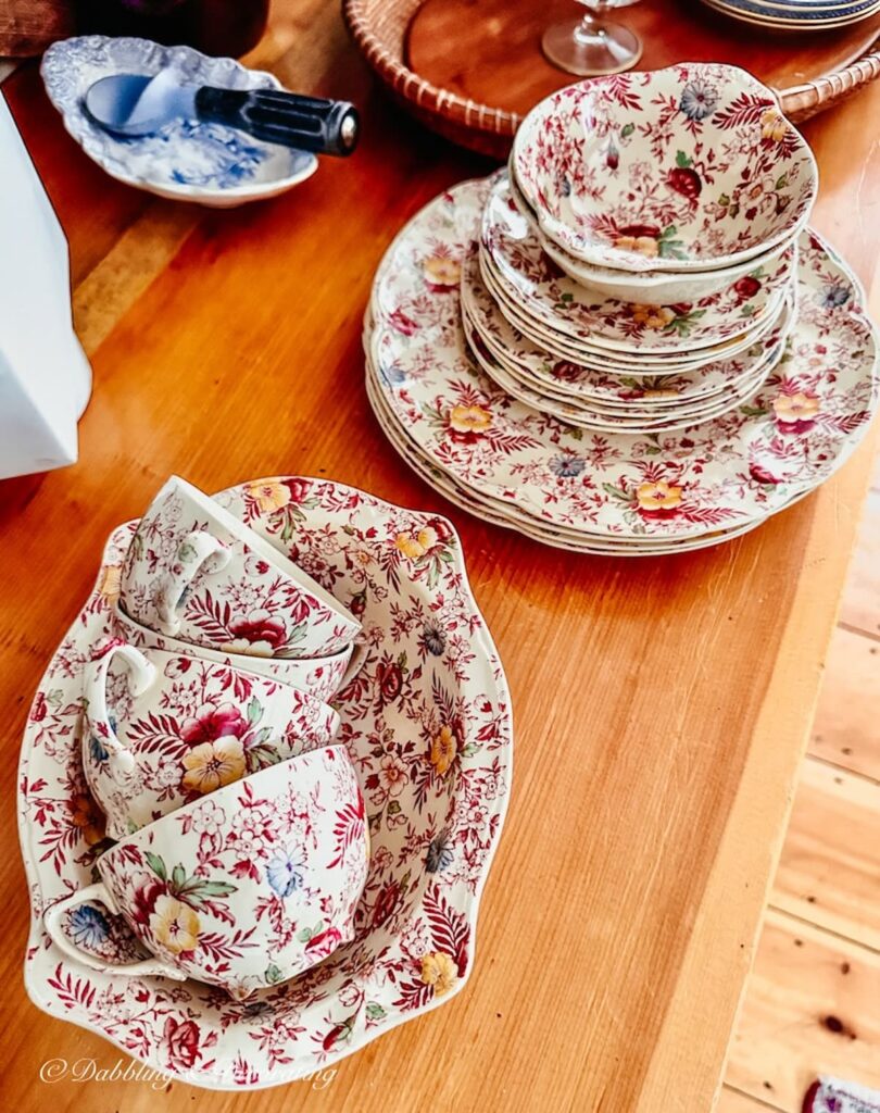 Set of Johnson Brothers vintage dinnerware in the Chintz pattern on wooden kitchen counter.