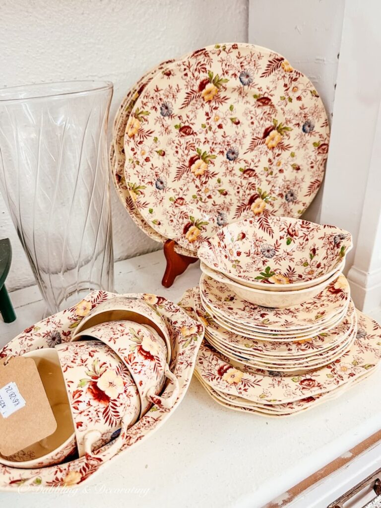 Set of Johnson Brothers vintage dinnerware in the Chintz pattern on thrift store shelf.