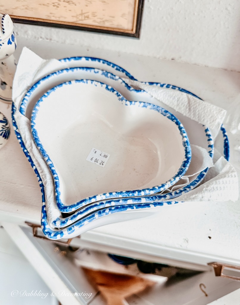 Blue and white porcelain heart nesting bowls in thrift shop.