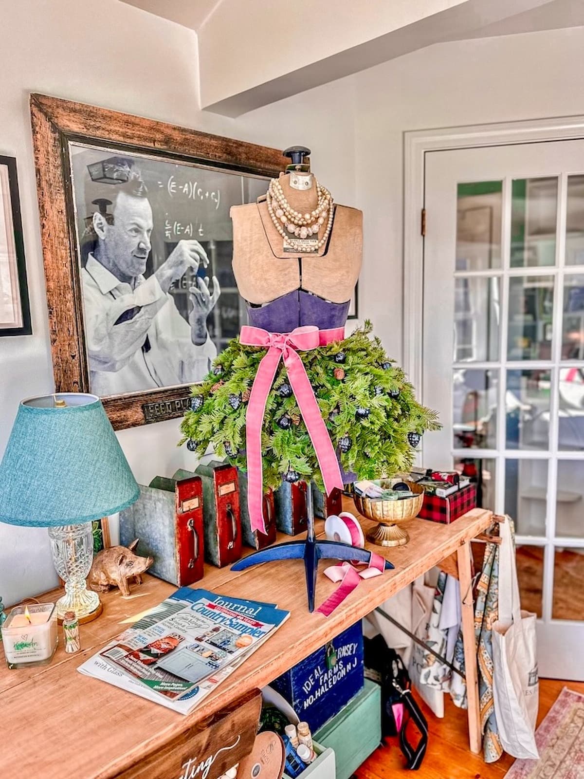 Christmas mannequin decoration ideas with evergreen dress and pink ribbon in under 15 minutes.