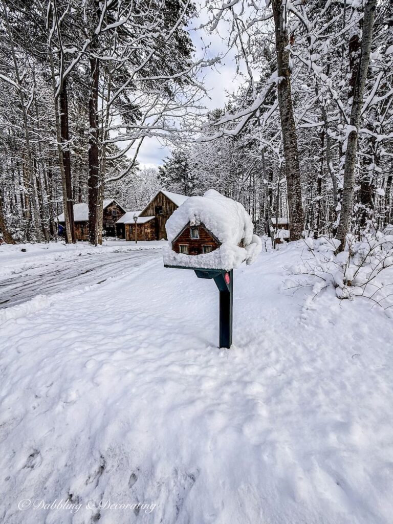 Cedar Shakes house mailbox covered in snow outside home in Maine.