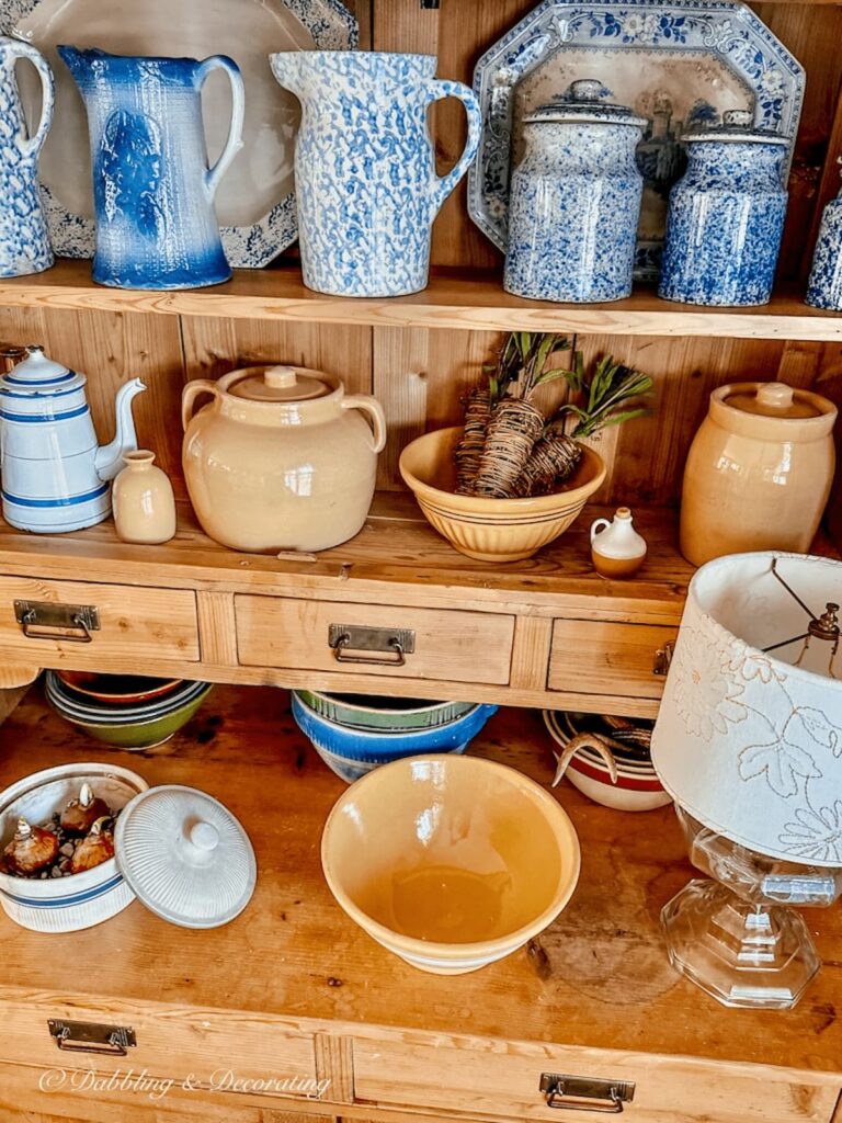 Vintage pine hutch with yellow and blue pottery.