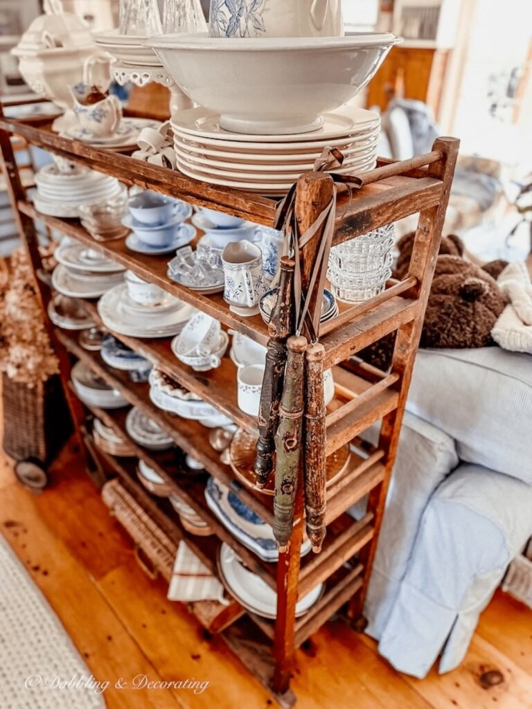 Vintage cobbler rack with hanging wooden spindles for the holidays. Also decorated with vintage collections.