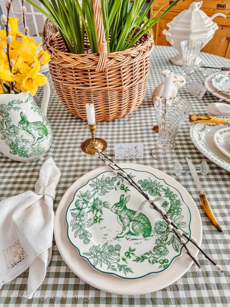 Green and white Easter Tablescape place setting with rabbits and Daffodils.