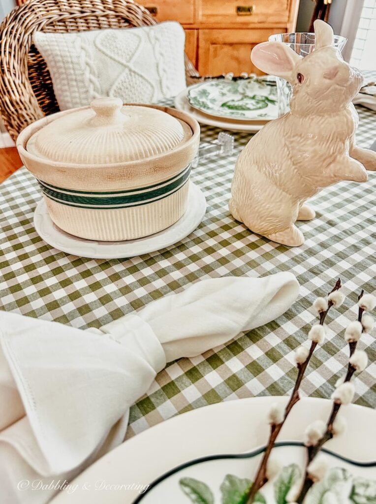 antique ironstone bowl with lid on green gingham tablescape with Easter bunny, linen napkin close up.