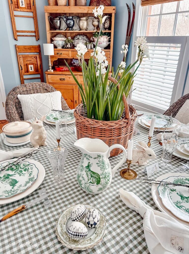 Green and white Easter Tablescape with green gingham and basket of paperwhites centerpiece.