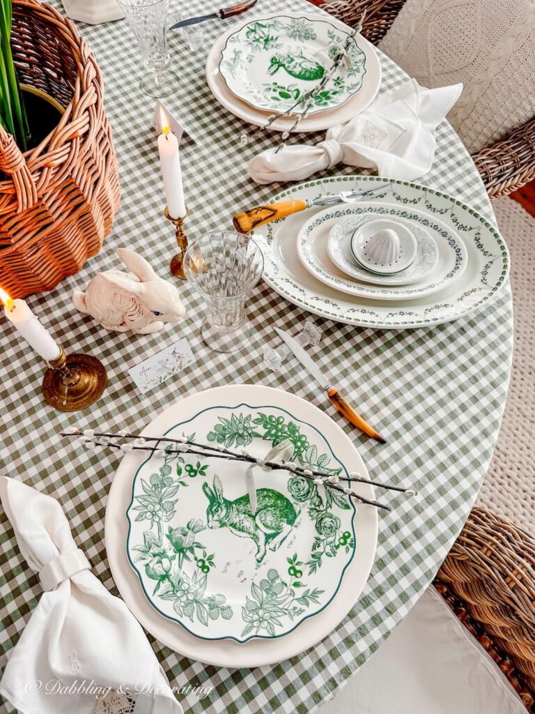 Wooden handled flatware on green and white Easter Tablescape.