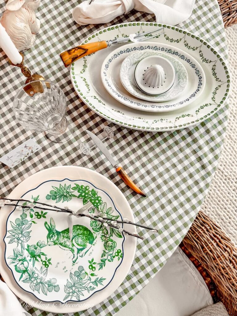Wooden handled flatware on green and white Easter Tablescape.