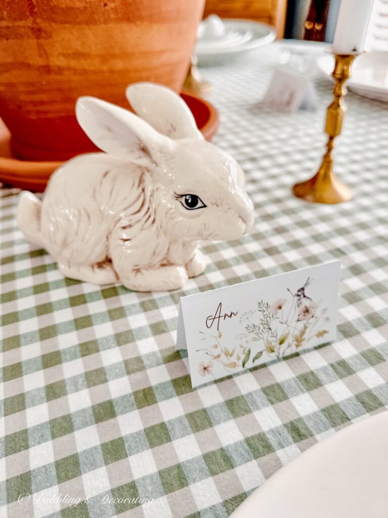 Ann Place Card on green and white plaid tablecloth for Easter Tablescape with ceramic white bunny.