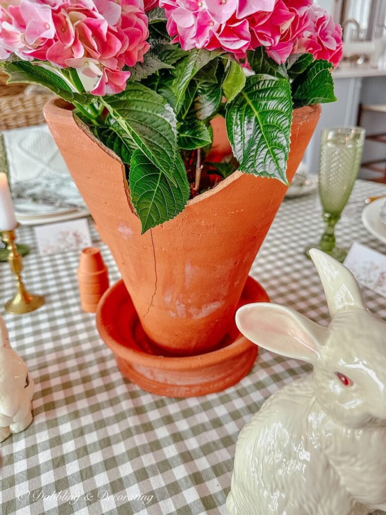 Terracotta Decor Pot with pink hydrangeas on green and white tablescape as centerpiece.