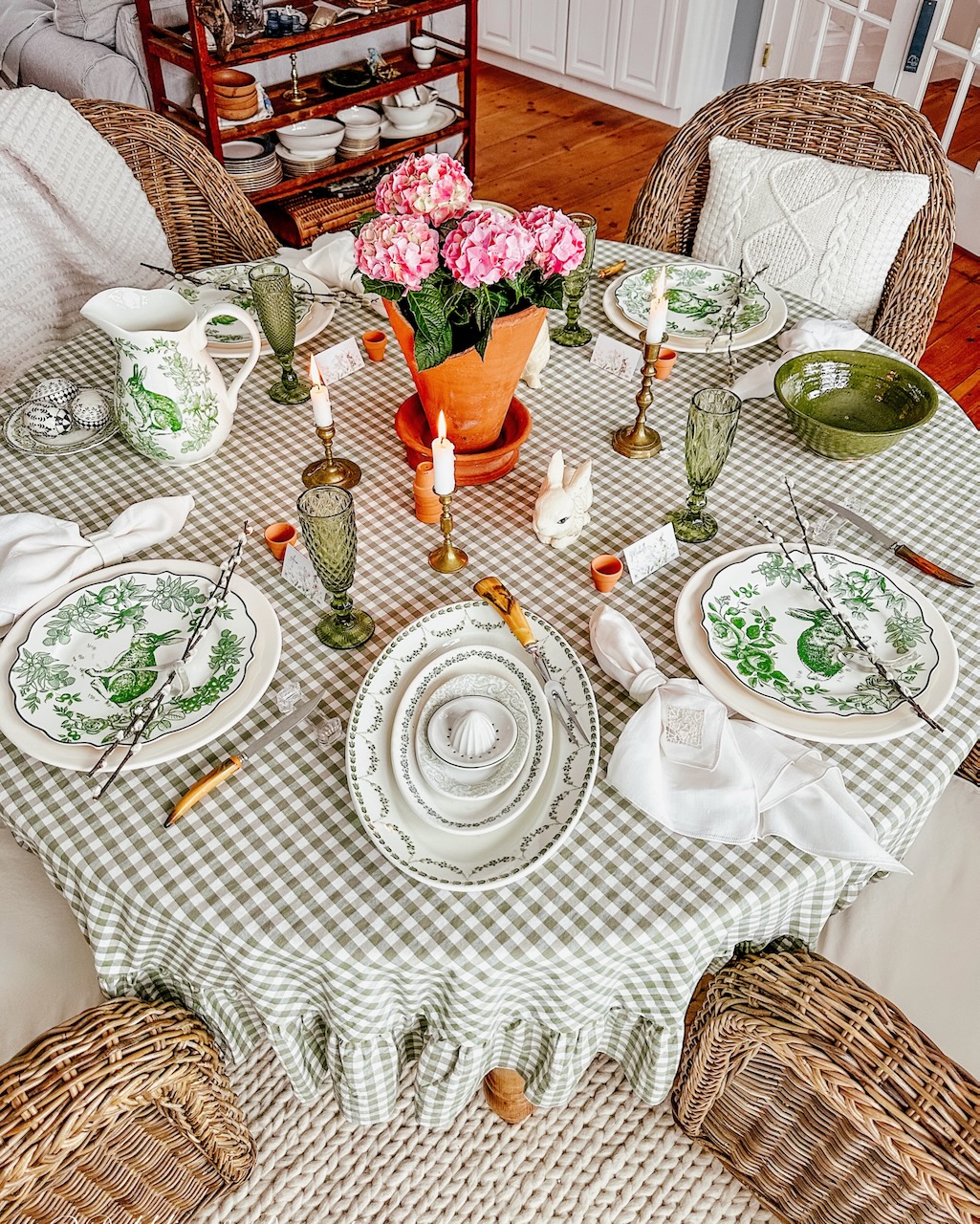 Easter Tablescape in green, pink, and white with gingham tablecloth and pink hydrangeas centerpiece.