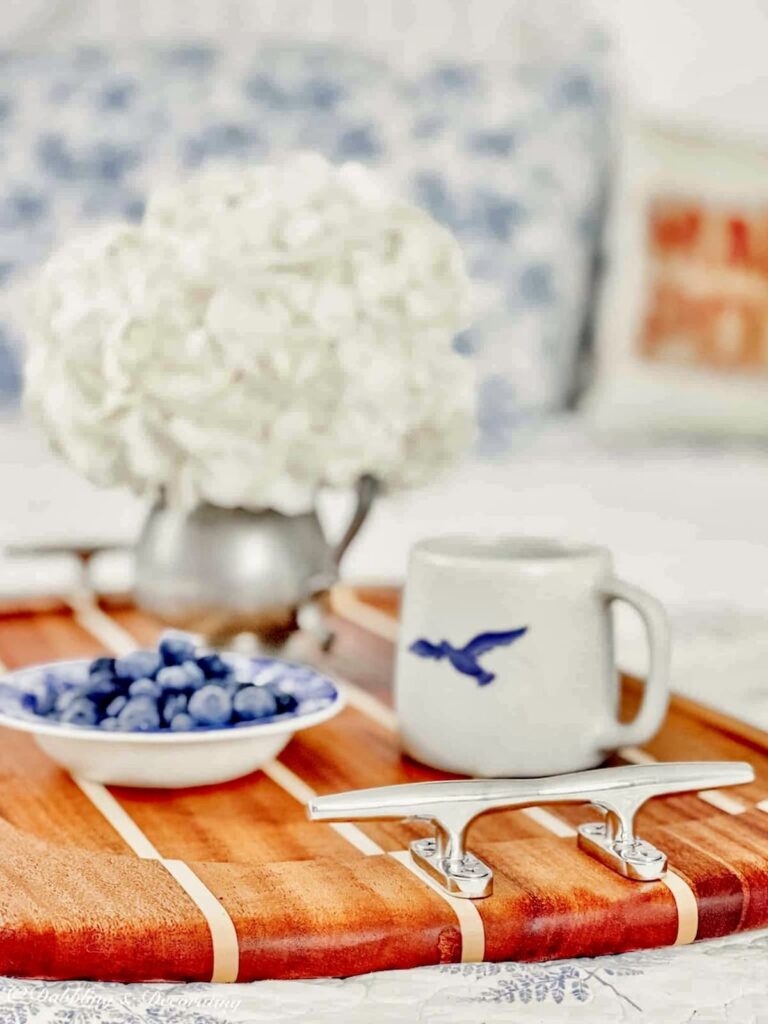 Nautical wooden serving tray with silver handles and morning breakfast in bed.