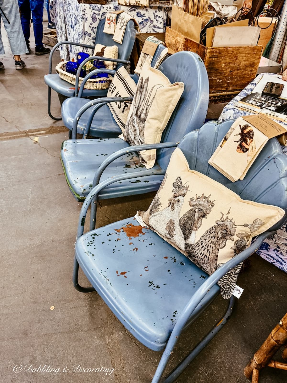 Antique blue outdoor metal chairs on display at Vintage Market Days.