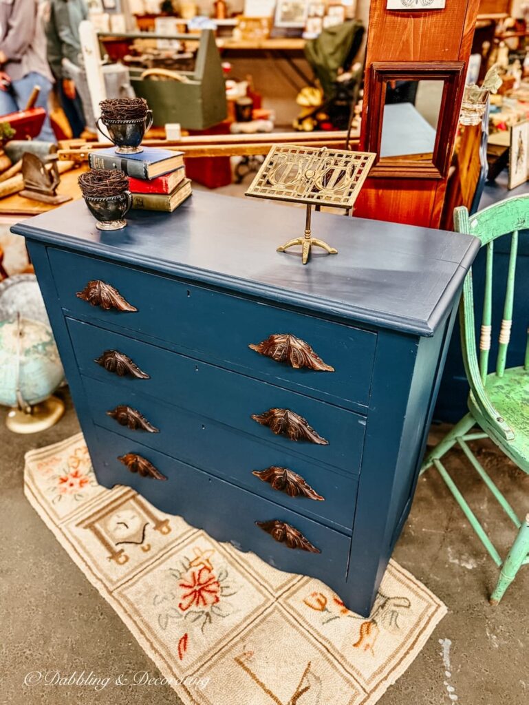 Navy antique dresser with oak wood handles at Vintage Market Days.