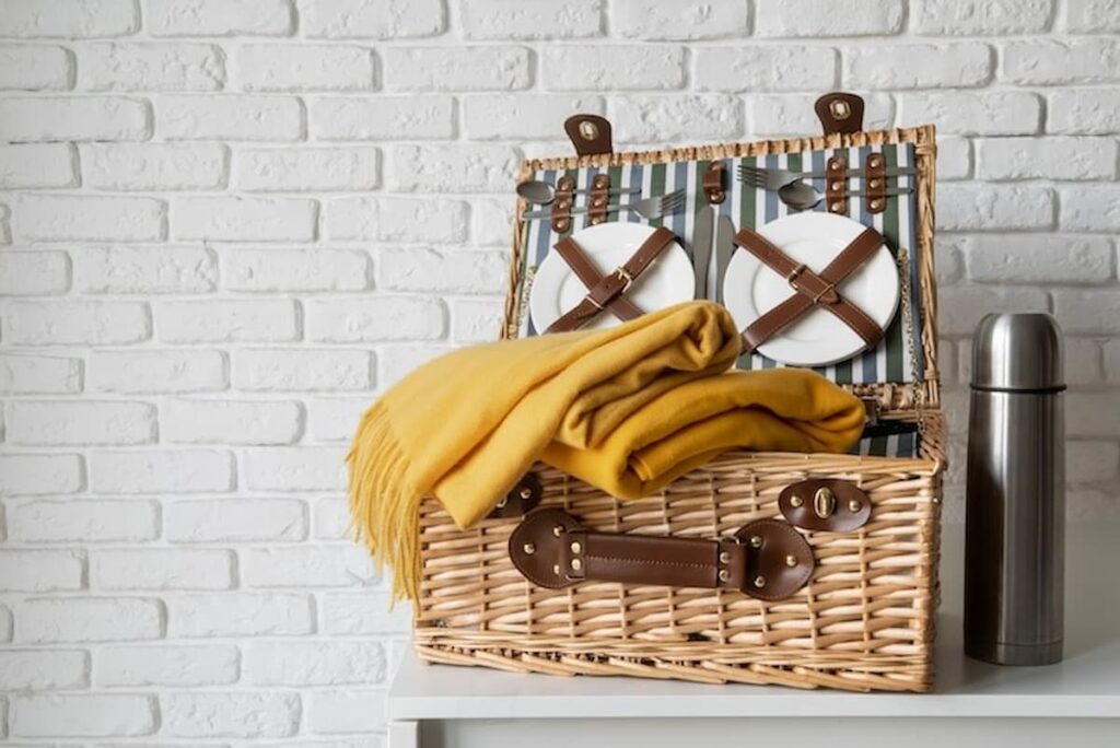 Modern Day picnic basket with dishes and yellow blanket for Vintage Picnic Basket Decorating ideas in modern decor.