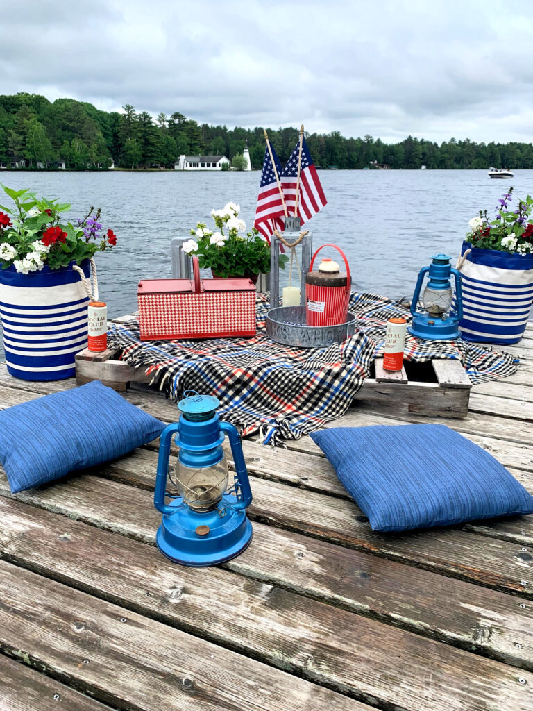 Vintage styled dock picnic on lake for Patriotic holiday.