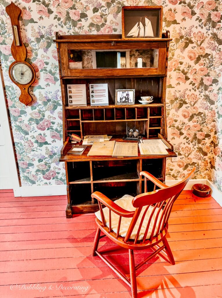 Antique desk with chair and old clock in Lobster Cove Lighthouse