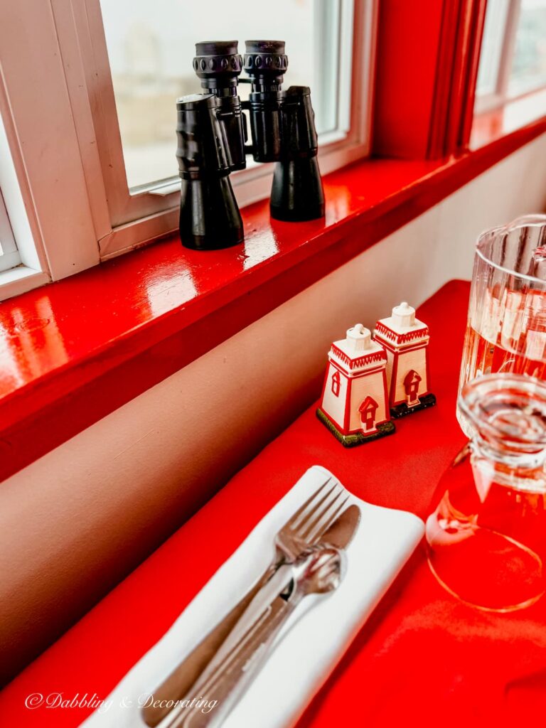 Vintage red and white lighthouse salt and pepper shakers on table at Lighthouse Keeper's Cafe.