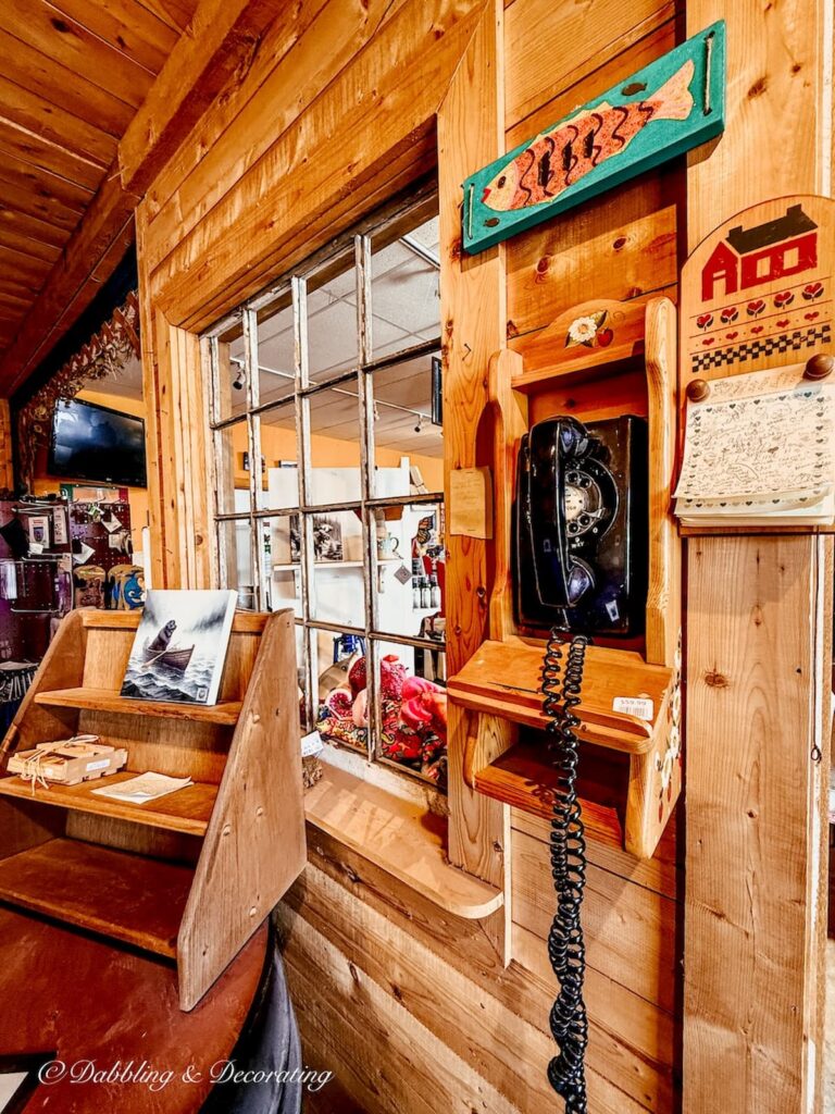 Vintage black telephone hanging on the wall antiquing in Newfoundland.