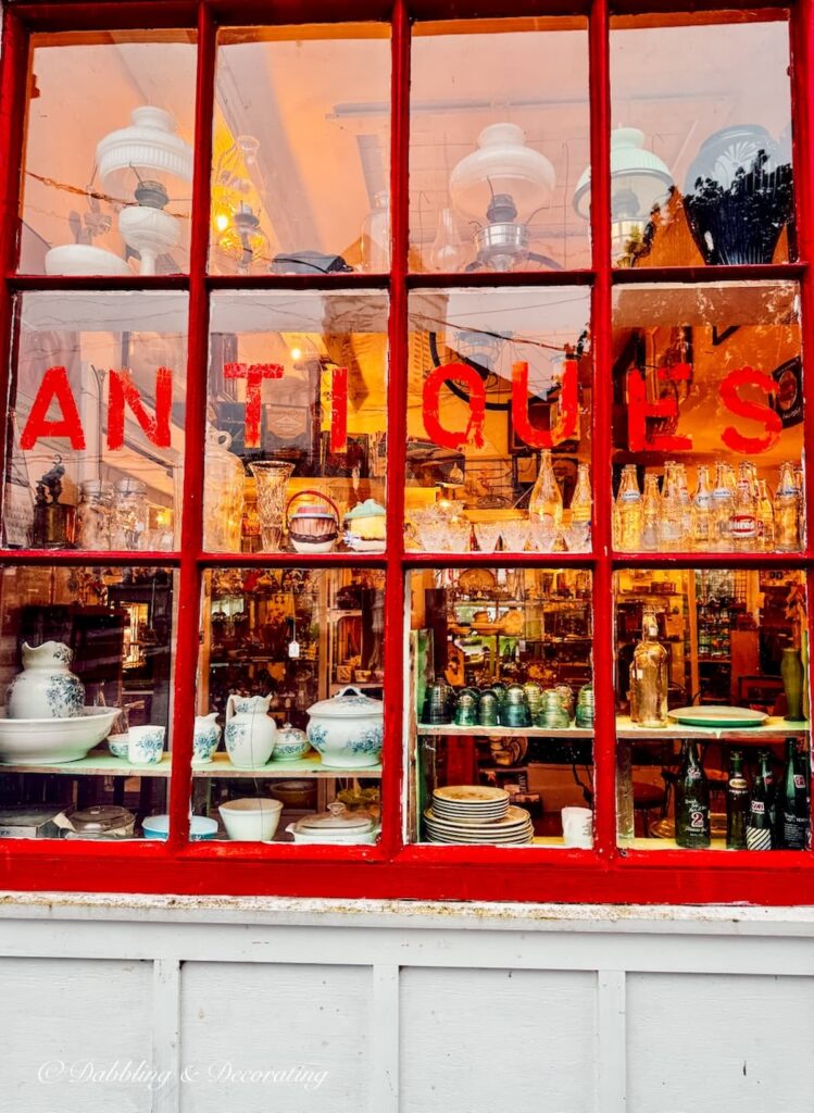 Red window with Antiques written in red lettering.