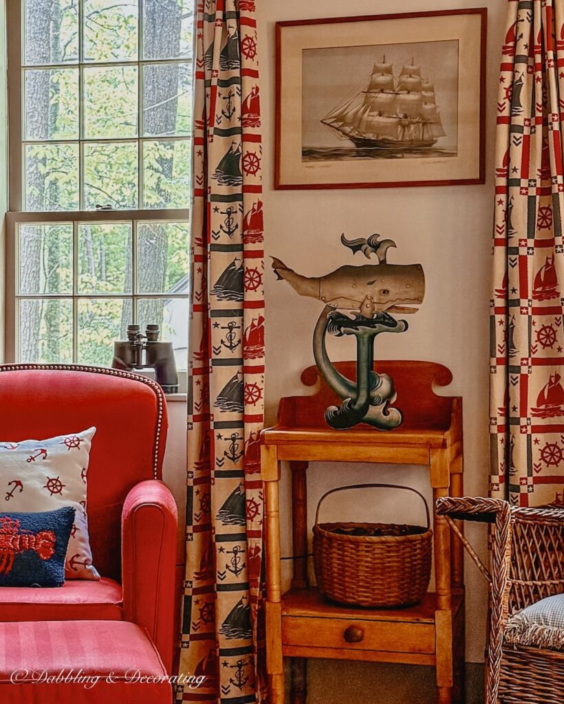 Living room with antique coastal decor and vintage binoculars on the windowsill.