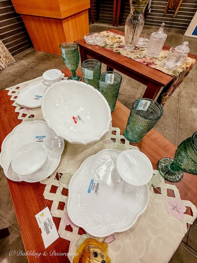 White milk glass display with green glassware for summer home style at Goodwill Northern New England.