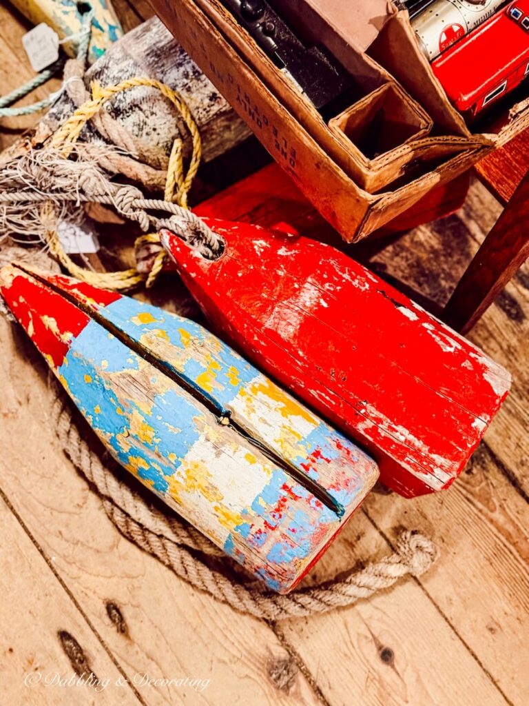 Red and blue vintage lobster buoys for coastal cottage decor ideas.