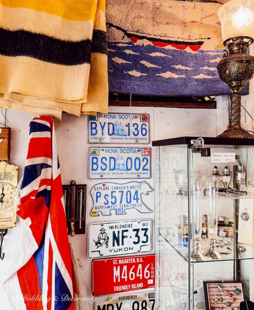 Antique shop in Nova Scotia with maritime flag hanging on wall in coastal cottage décor ideas.