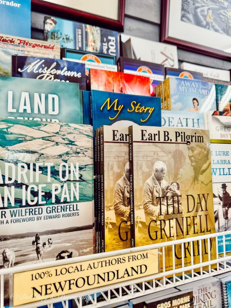 Rack of local authored books from Newfoundland in souvenier shop an example of coastal cottage décor ideas.