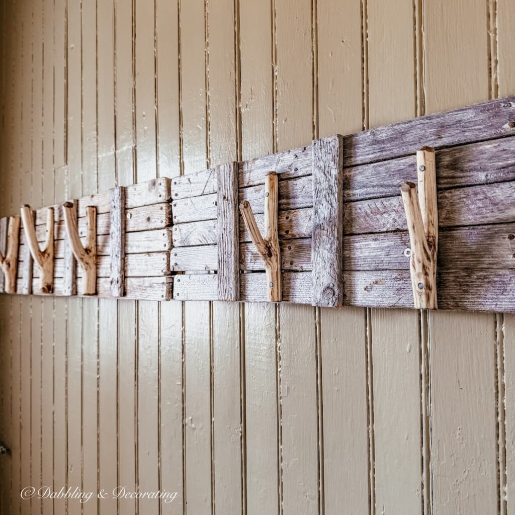 Driftwood handmade coat rack on wall.