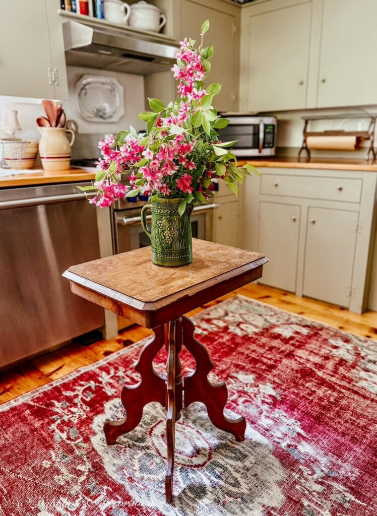 Vintage green McCoy pitcher found at Goodwill New England in Summer Home Decor in kitchen styled with pink flowers.