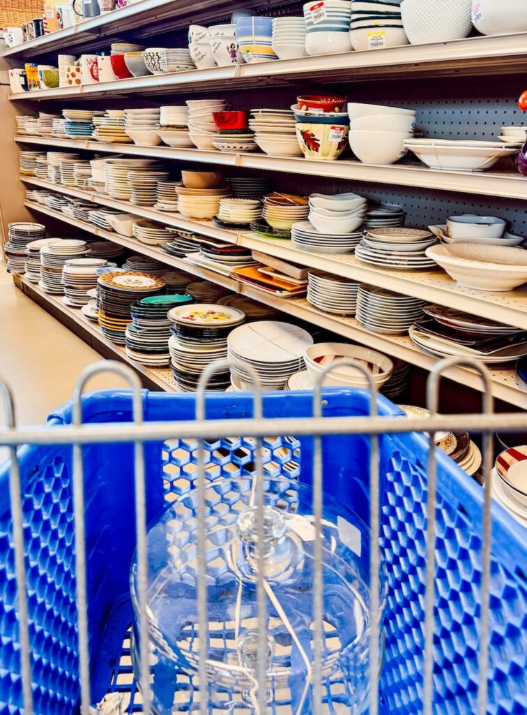 Glass cake stand and cover in Goodwill shopping cart in dish isle, Summer Home Decor Finds.