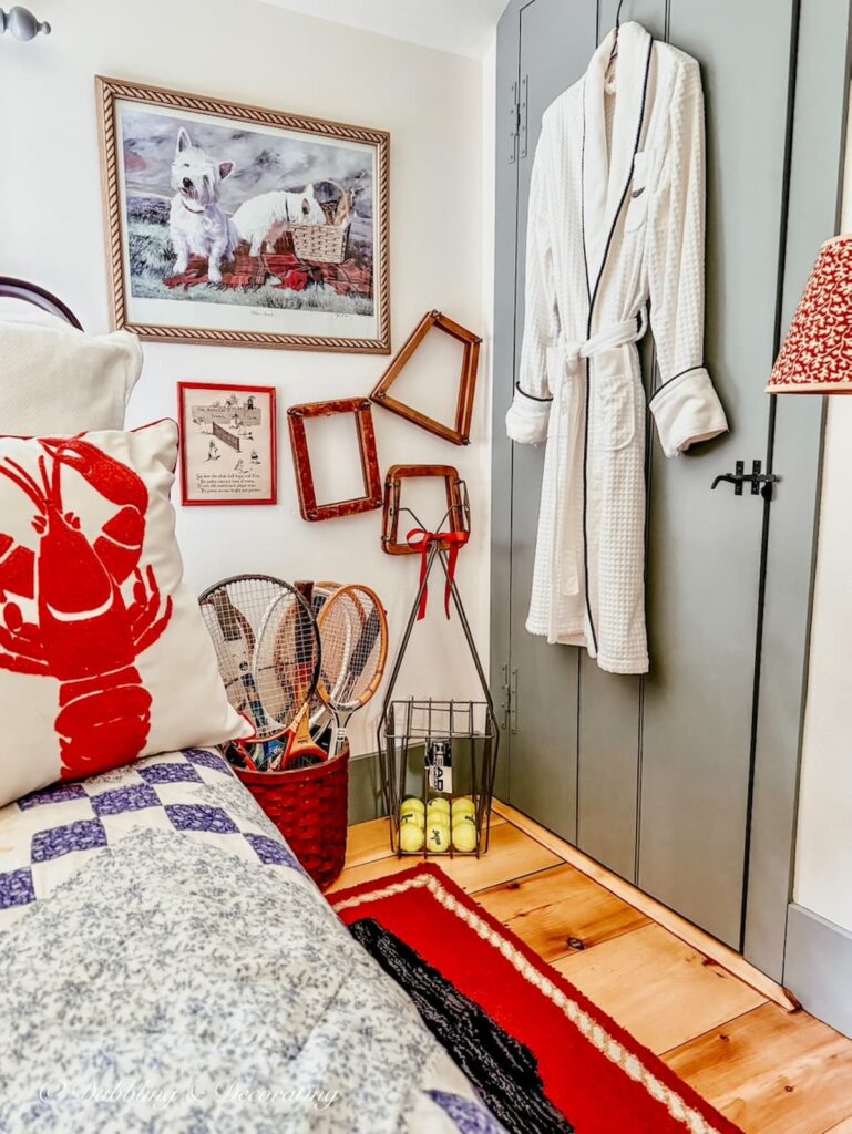 Bedroom corner with basket of tennis rackets and a tennis ball hopper filled with tennis balls, summer decor finds from Goodwill.
