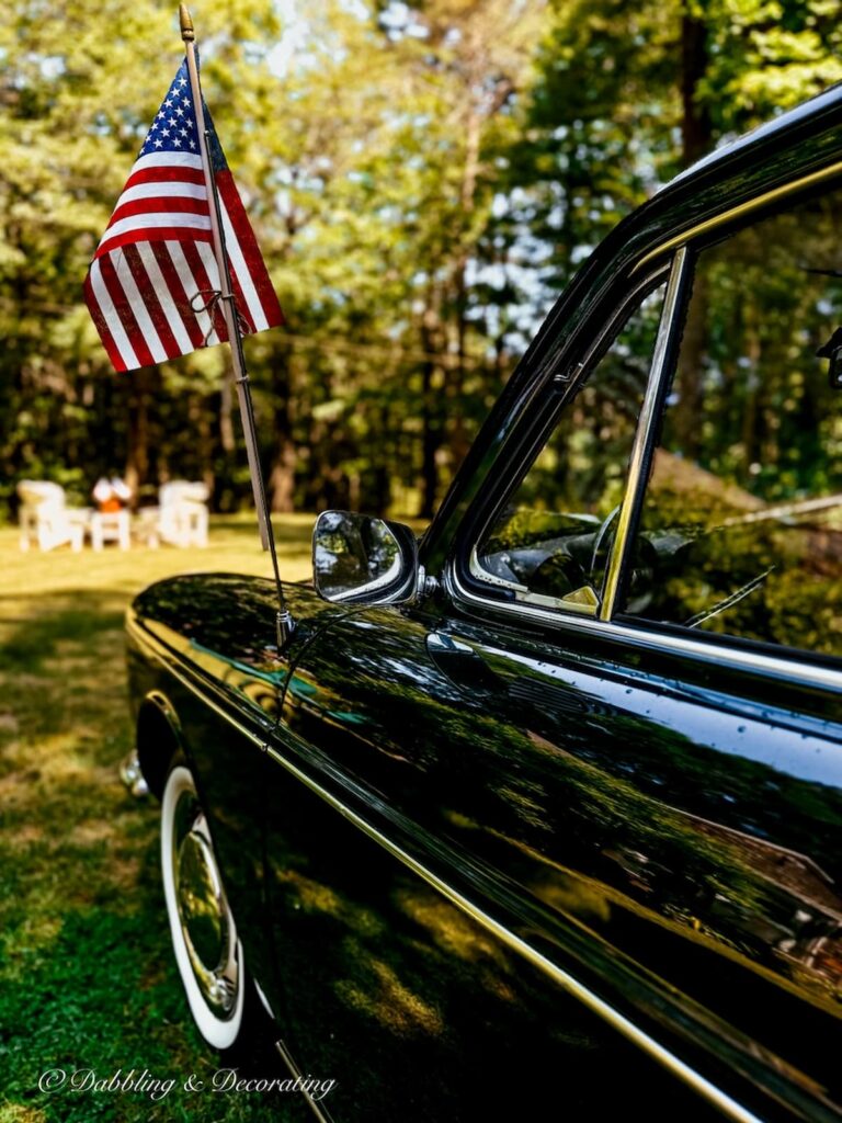 4th of July Patriotic Vintage Car Styling Ideas USA flag tied to a vintage car radio antenna for styling.