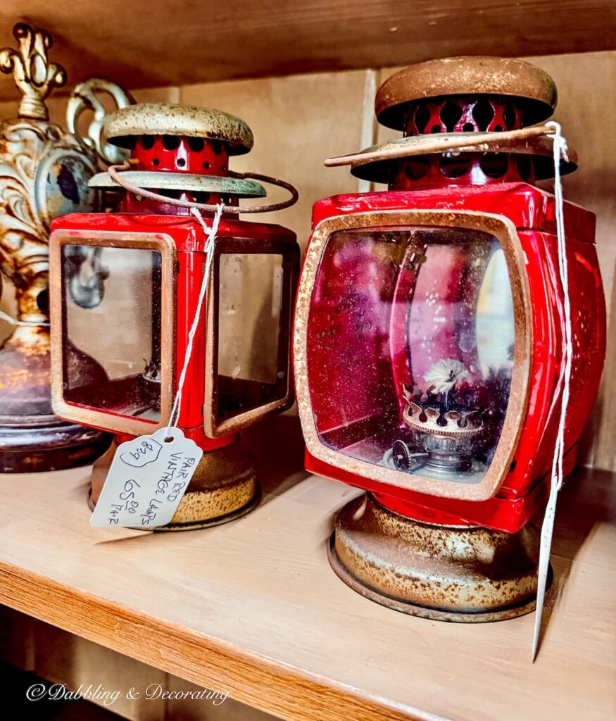 Two red antique carriage lanterns in antique store in Maine.
