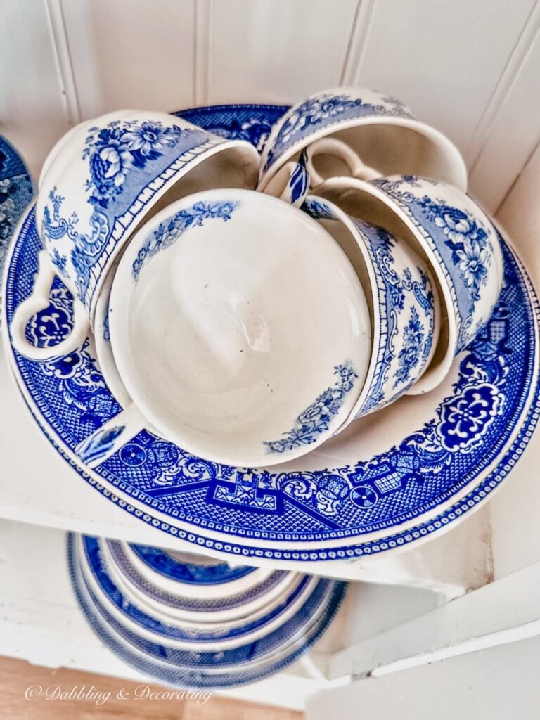 Blue and white Johnson Brothers China Bowl with teacups in thrift shop.