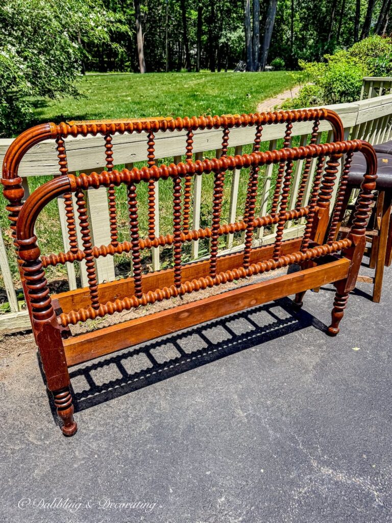 Antique Jenny Lind bed at yard sale.
