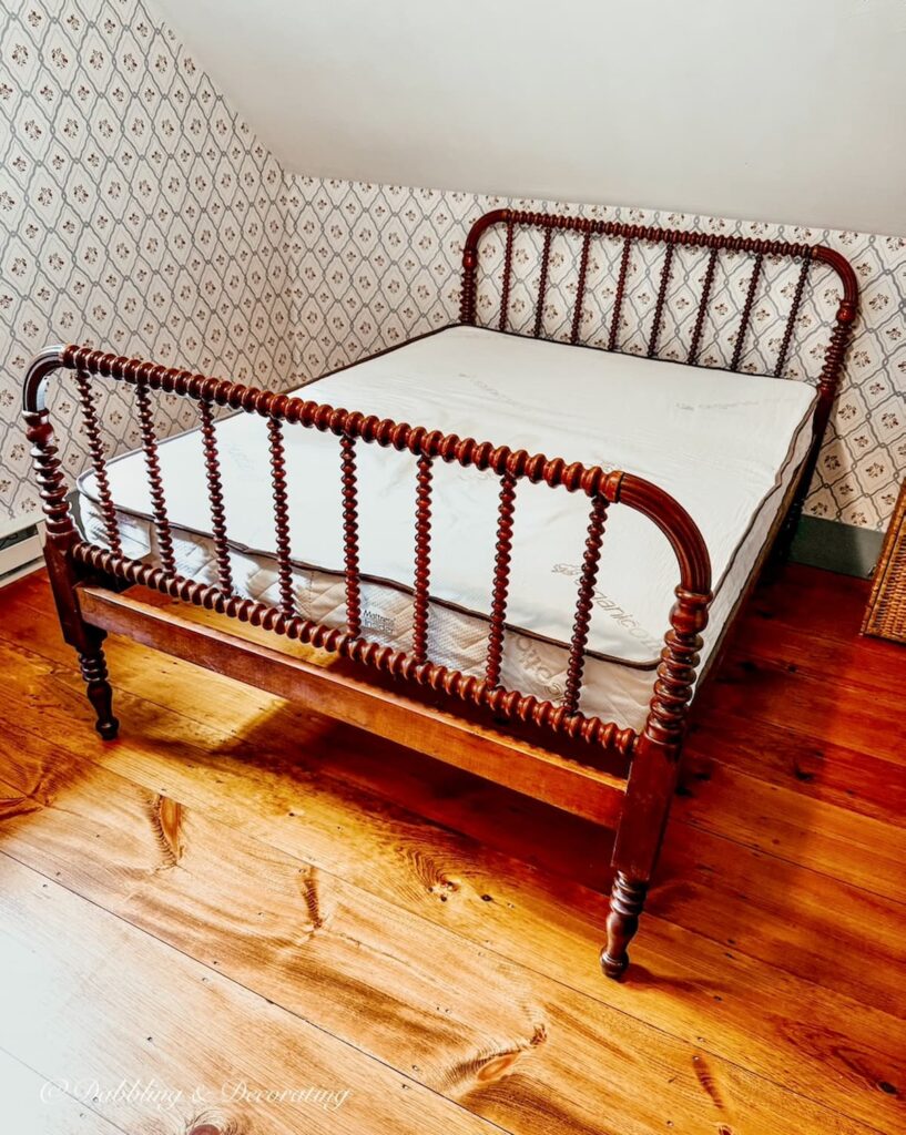 Antique Jenny Lind bed in coastal home attic bedroom with custom mattress.