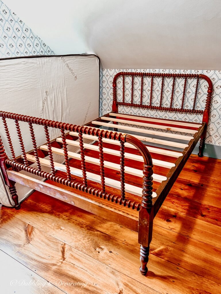 Antique Jenny Lind bed  waiting for custom mattress in coastal Maine home's bedroom.