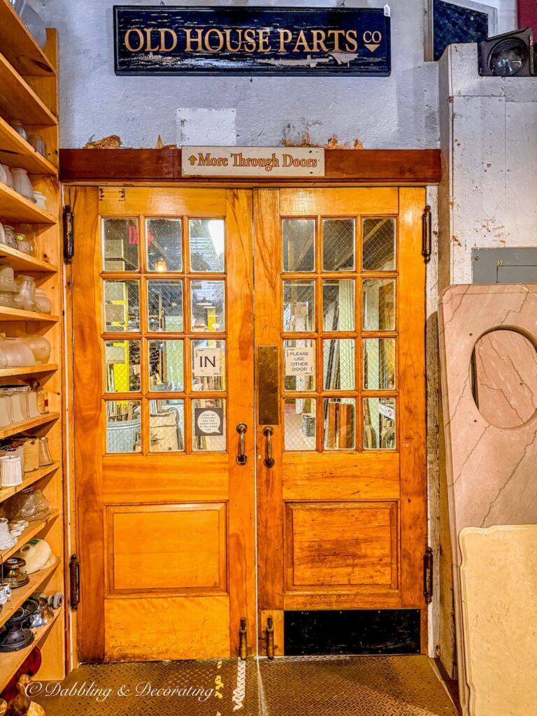 Two wooden doors entering into Old House Parts Company Kennebunk, Maine.