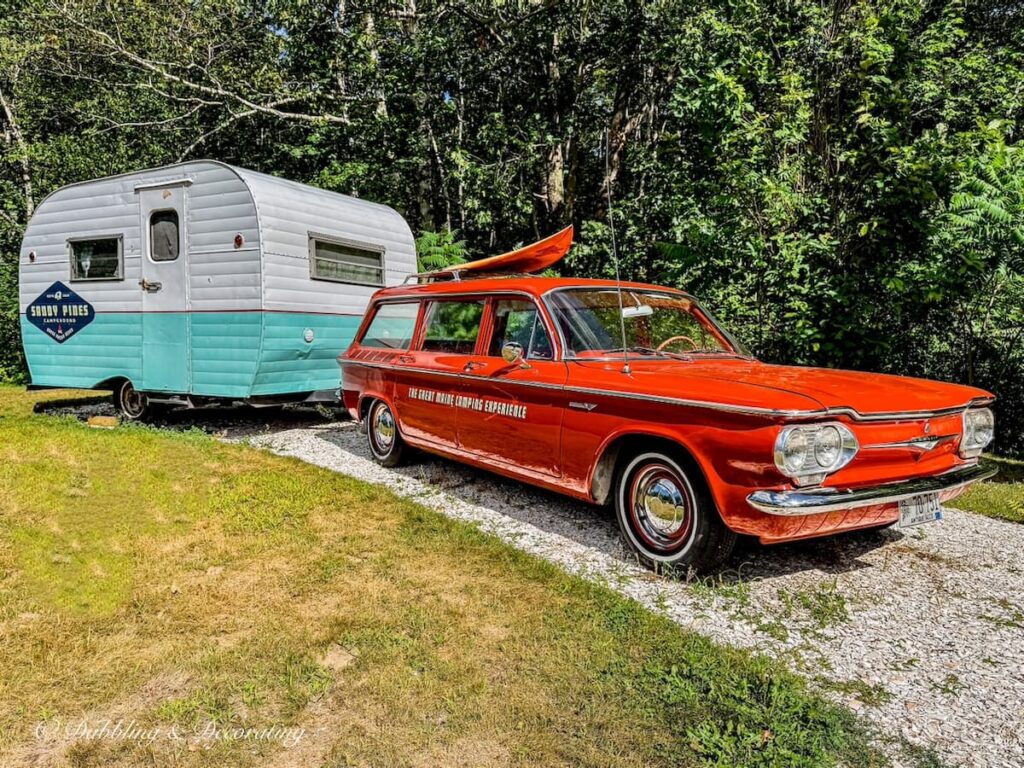 Vintage Orange Corvair beach stationwagon with retro camper at Sandy Pines Campground in Kennebunk, Maine.