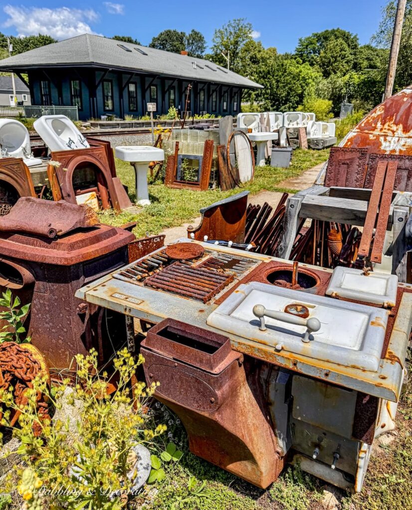 Architectural salvage outdoors including old bathtubs and porcelain sinks at The Old House Parts co. Kennebunk, Maine.
