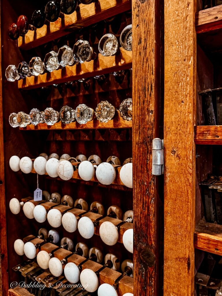 Cabinet filled with antique door knobs of all kinds.