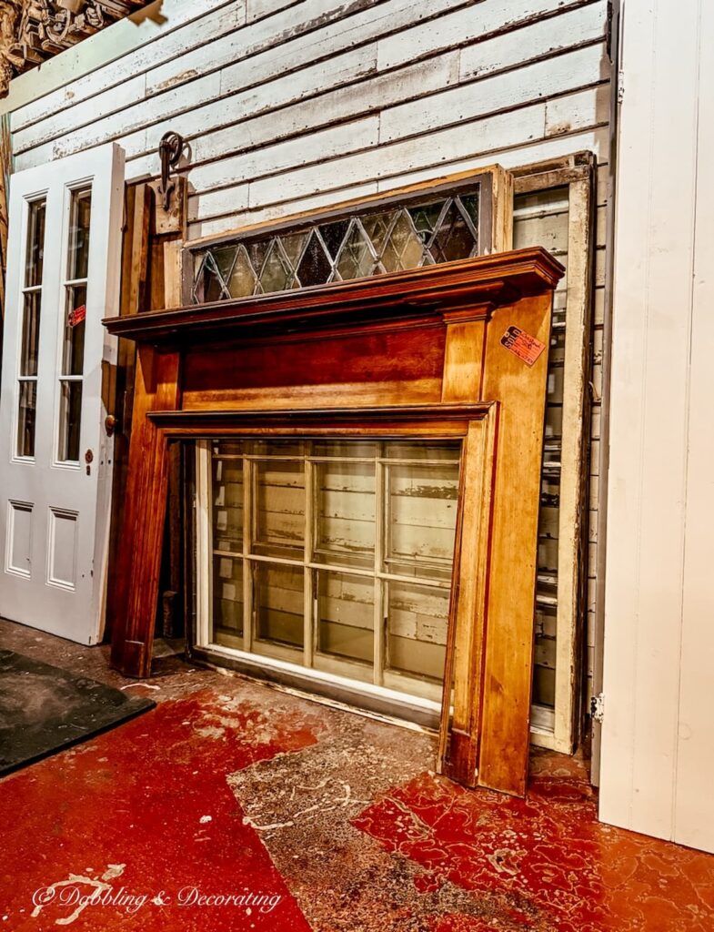Large wooden antique mantel for house layered in antique store.