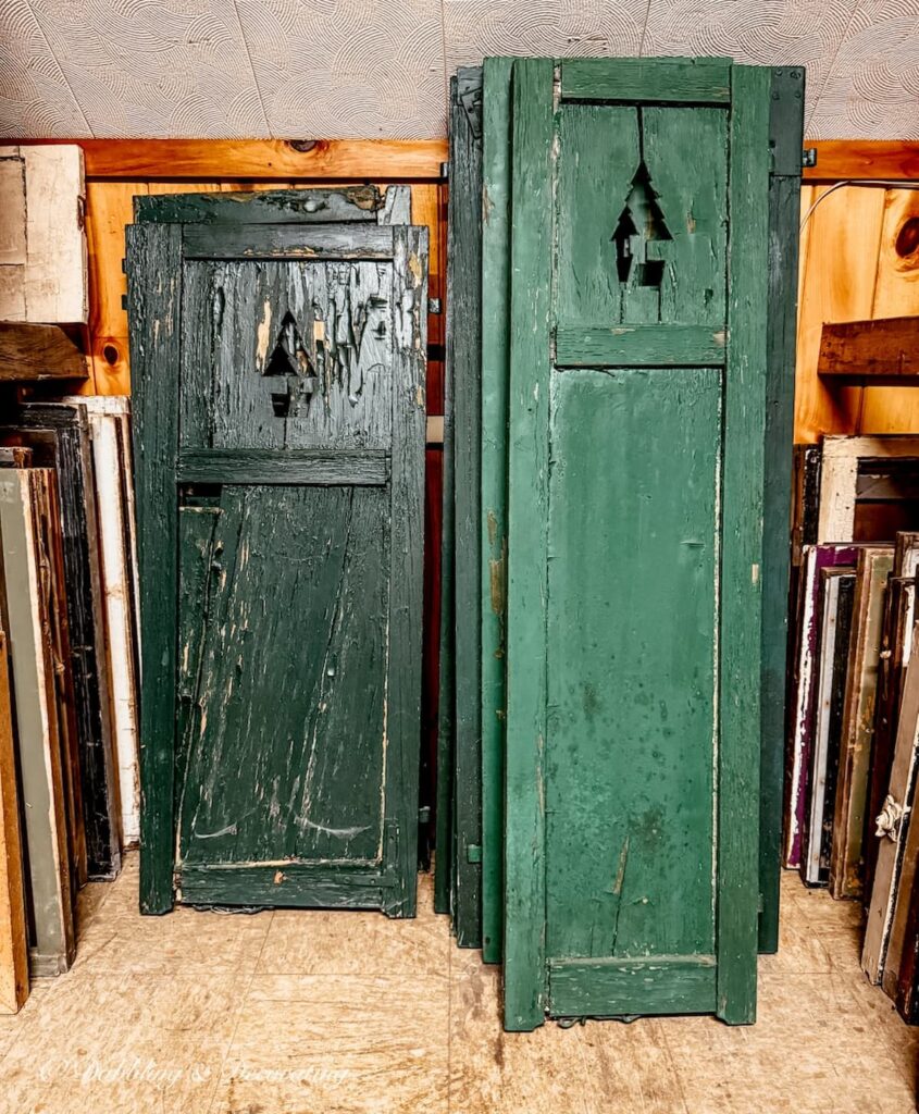 Green shutters stacked with Christmas Tree impressions at The Old House Parts Co.