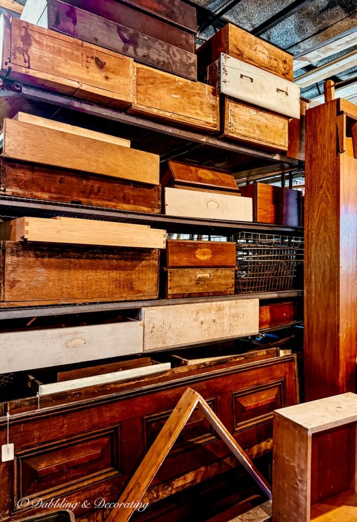 Wall of salvaged antique wooden drawers in all shapes, sizes, and ages.