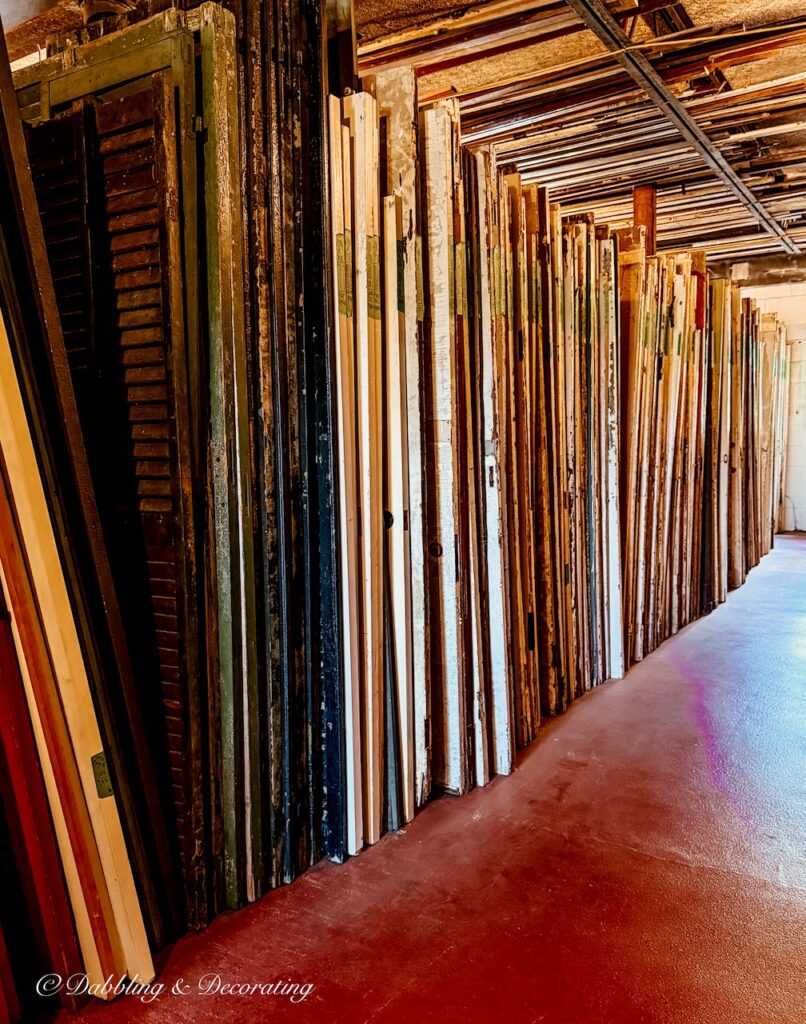 Row of neatly organized salvaged old doors at The Old House Parts Co.